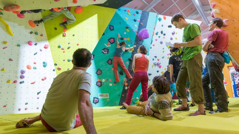 Image of a group of climbers enjoying bouldering at a competition