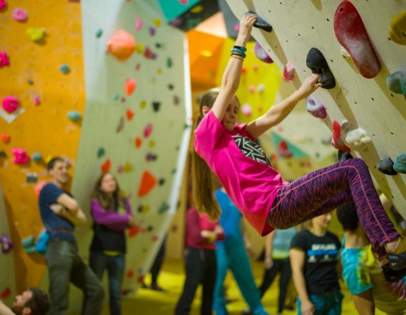 Image of a girl enjoying bouldering at a competition